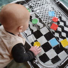 Load image into Gallery viewer, Black and white water mat, baby water mat, high contrast water mat, black and white baby toy, tummy time mat, Young wonderer, Young wonderer baby boutique, black and white baby toy, australian baby boutique, high contrast toy, baby toy, tummy time toy, sensory toy, baby sensory, sensory mat
